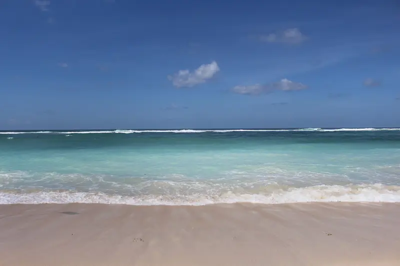 Clear turquoise shallows meeting the white sand at Pandawa Beach
