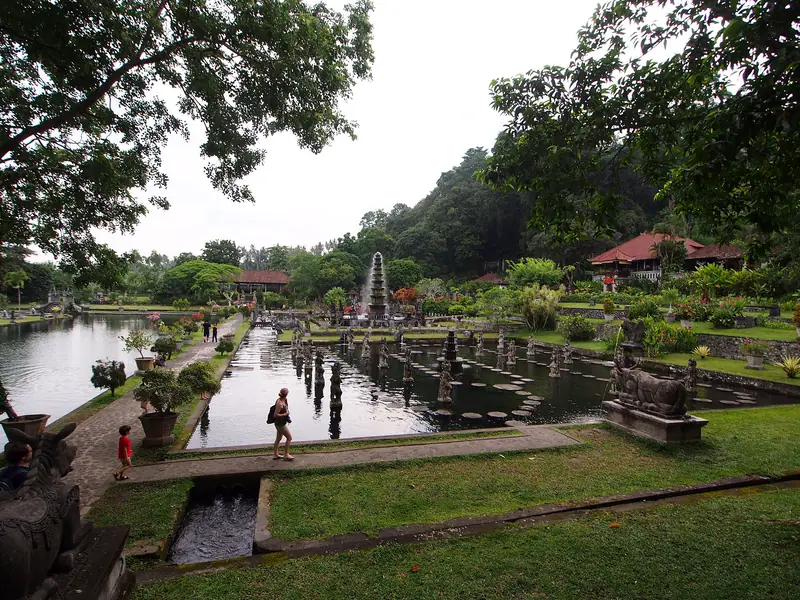 The water gardens at Tirta Gangga, with stepping stones crossing the pond between stone statues